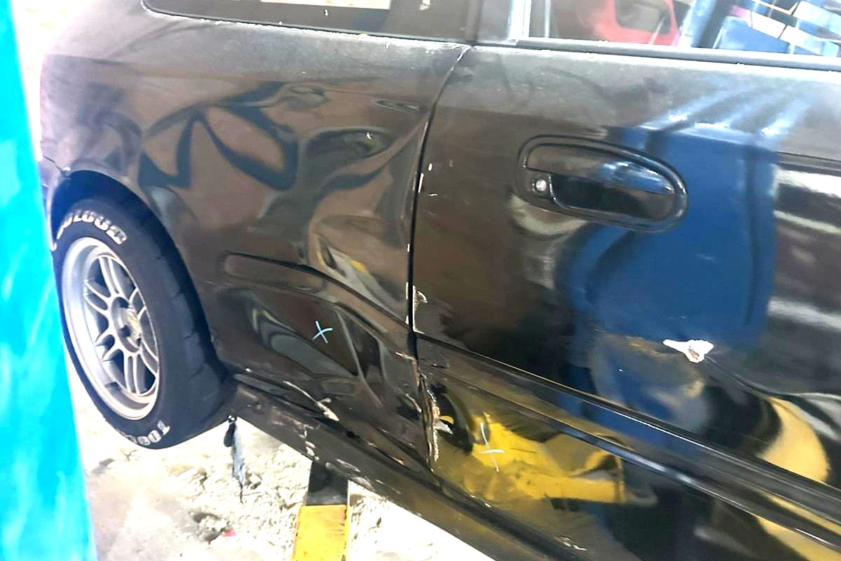 Before: Honda Civic with the door and rear quarter creased by collision damage