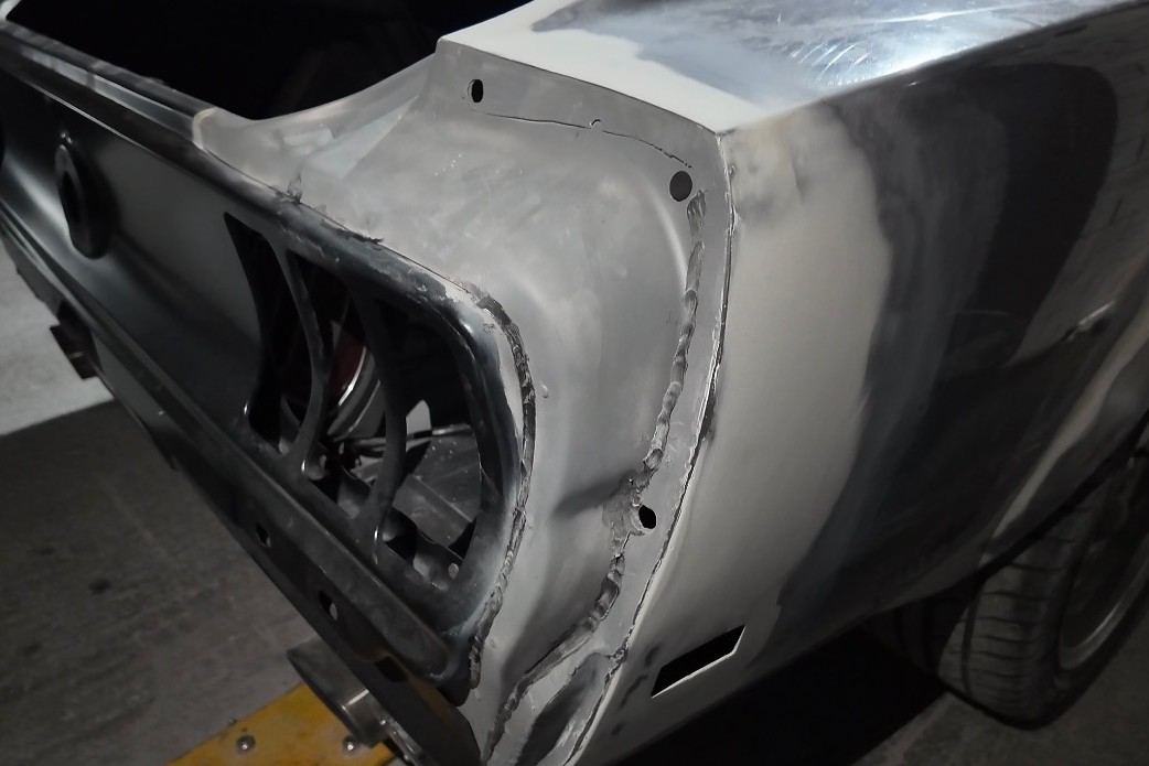 Before: Mustang Mach 1 rear quarter panel welded in and still in bare metal